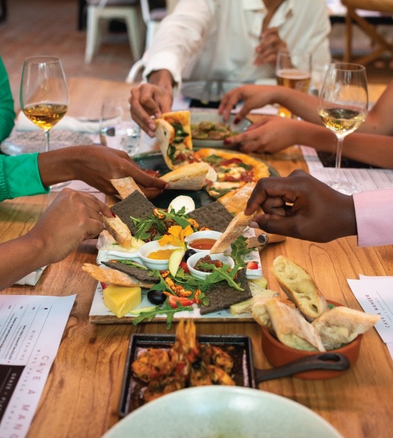 Sharing plates and wine at Cave à Manger