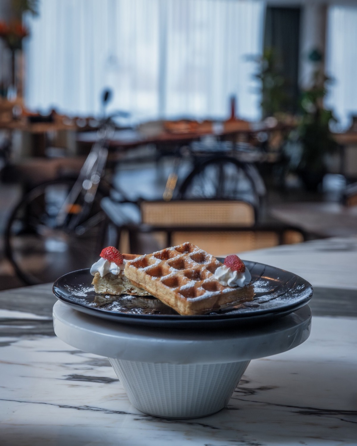 Waffles with cream and strawberries at Enchante Bistro