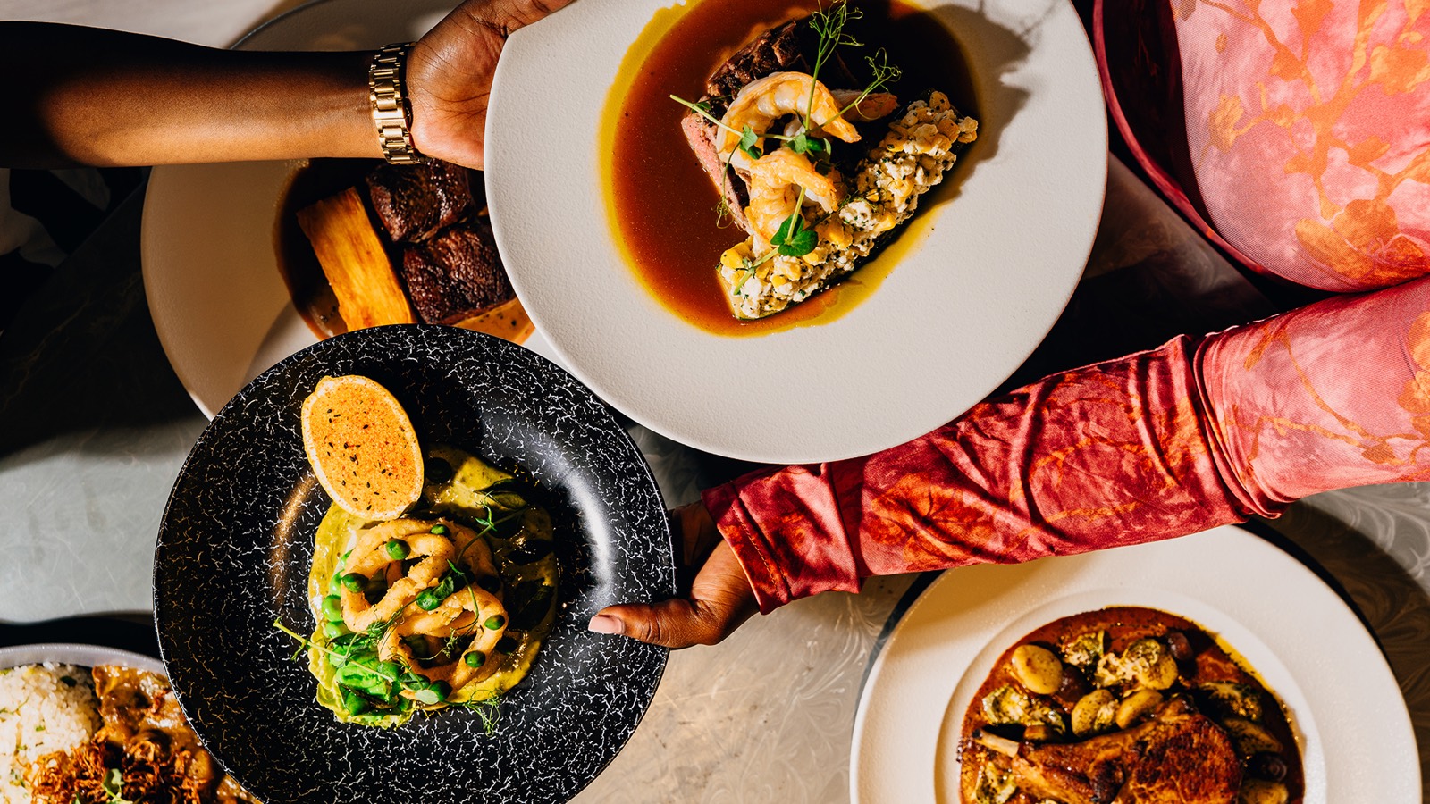 Dishes shared at a table at Glow Restaurant